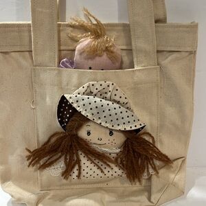 Canvas doll bag vintage 1980’s, 8” high, color: beige. Comes with 2 dolls.